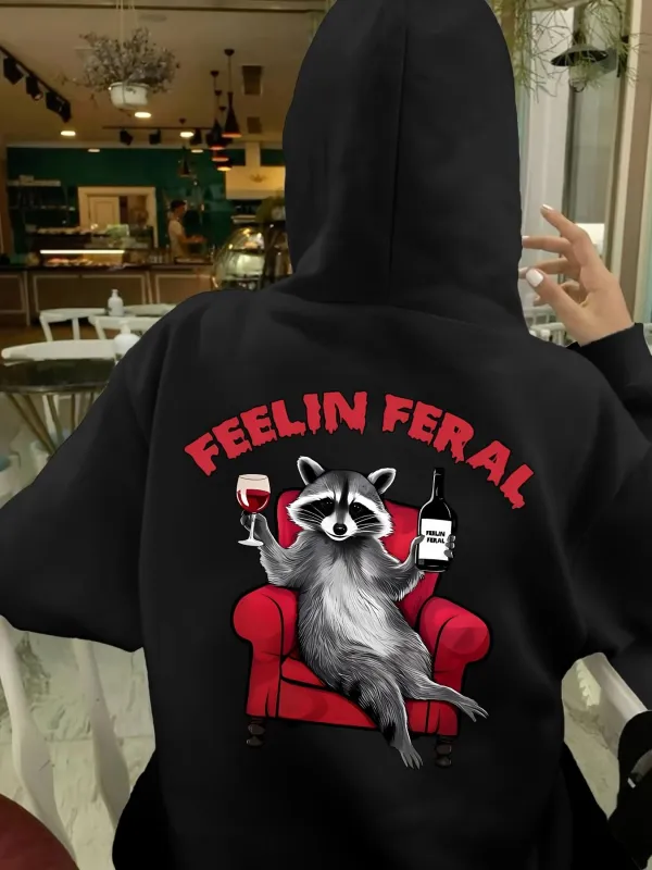 Tailorly Women's Printed Hoodie - Feelin Feral Relaxed Raccoon Lounging On Red Armchair With Wine And Bottle made by Tailorly