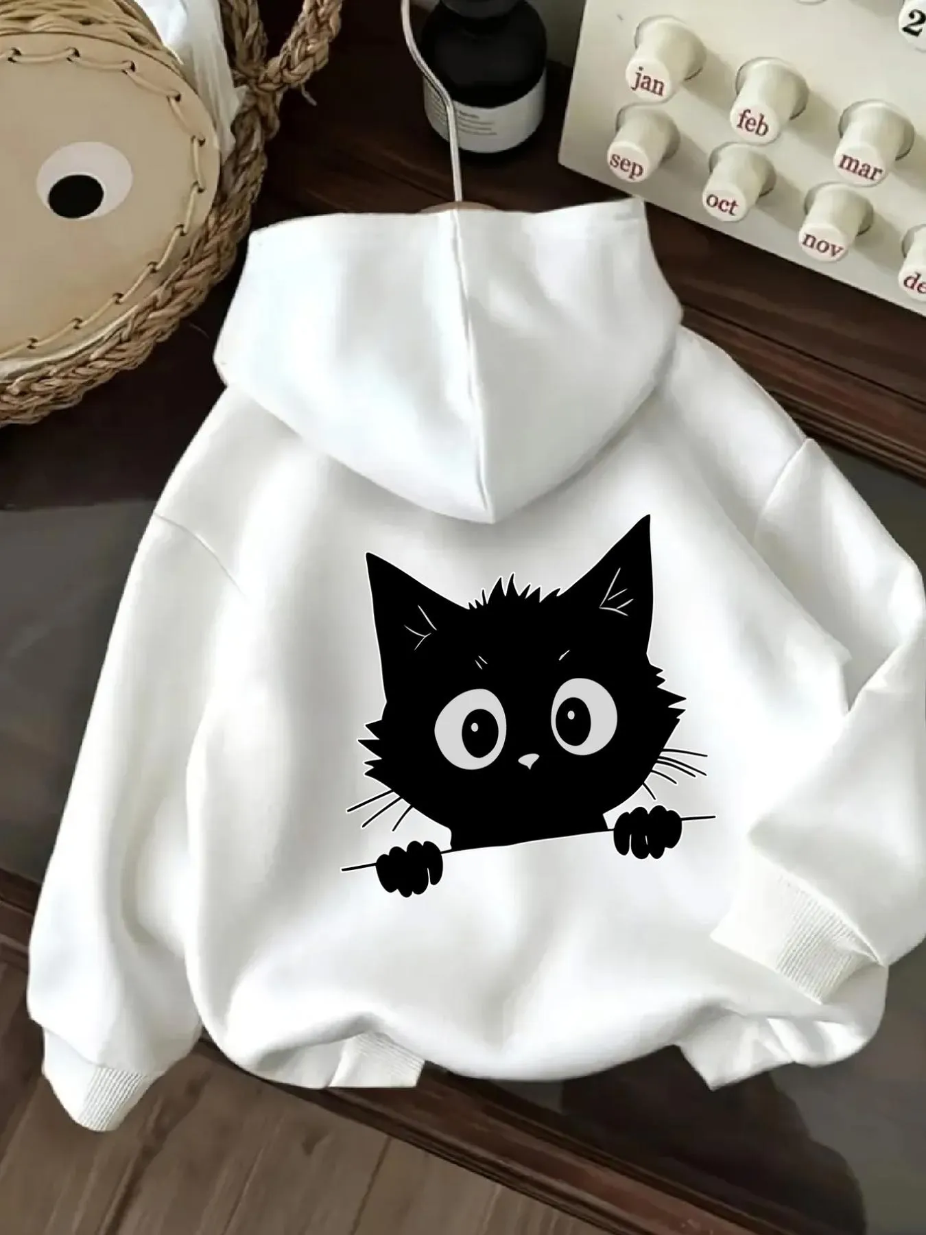 Tailorly Women's Printed Hoodie - Playful Black Cat Peeking Out With Whiskers And Wide Bright Eyes Cat sold by Tailorly