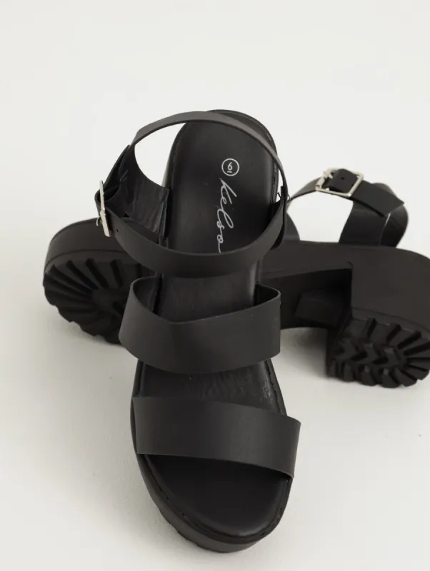 Ladies Buckle Strap Cleated Platform Heeled Sandal - Black sold by Edgars