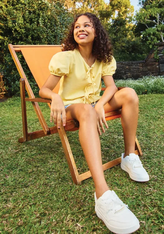 Girls Puff Sleeve Front Bow Detail Peplum Top - Pastel Yellow sold by Edgars