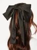 Satin Oversized Bow Hair Clip in Black sold by Skinnydip London