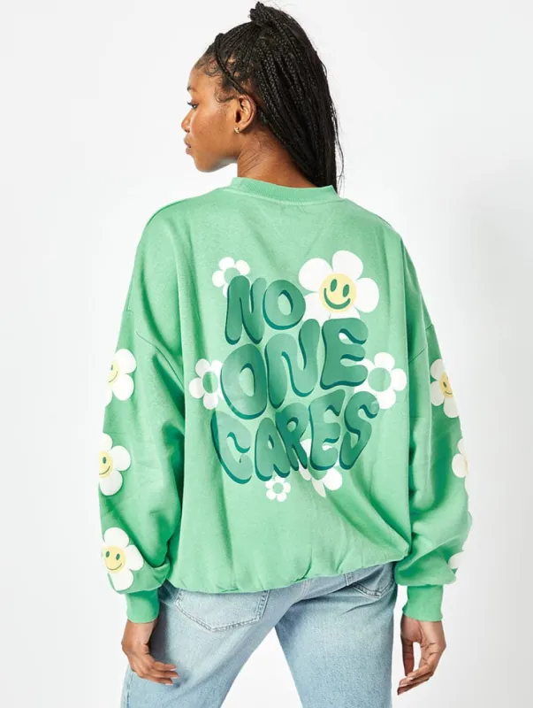 No One Cares Oversized Sweatshirt in Washed Green sold by Skinnydip London