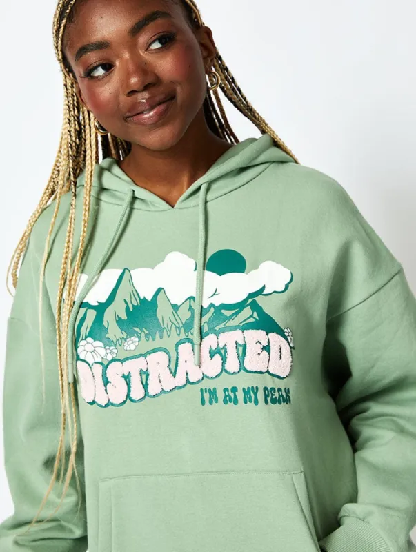 Distracted Hoodie in Sage Green sold by Skinnydip London