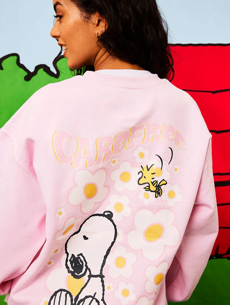 Peanuts x Skinnydip Snoopy Carefree Sweatshirt in Pink sold by Skinnydip London
