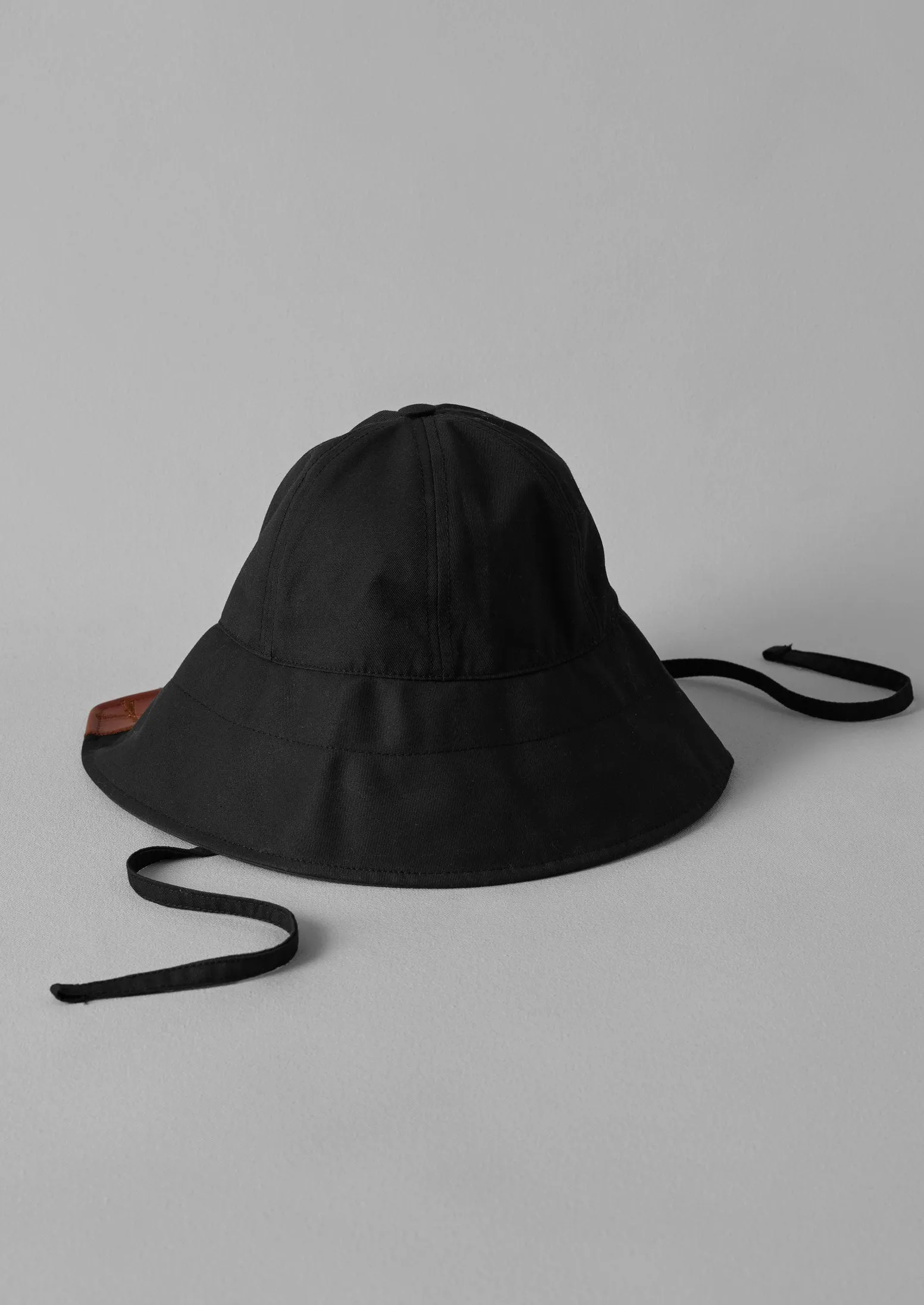 Beton Cire Contrast Rain Hat | Black/Brown sold by TOAST