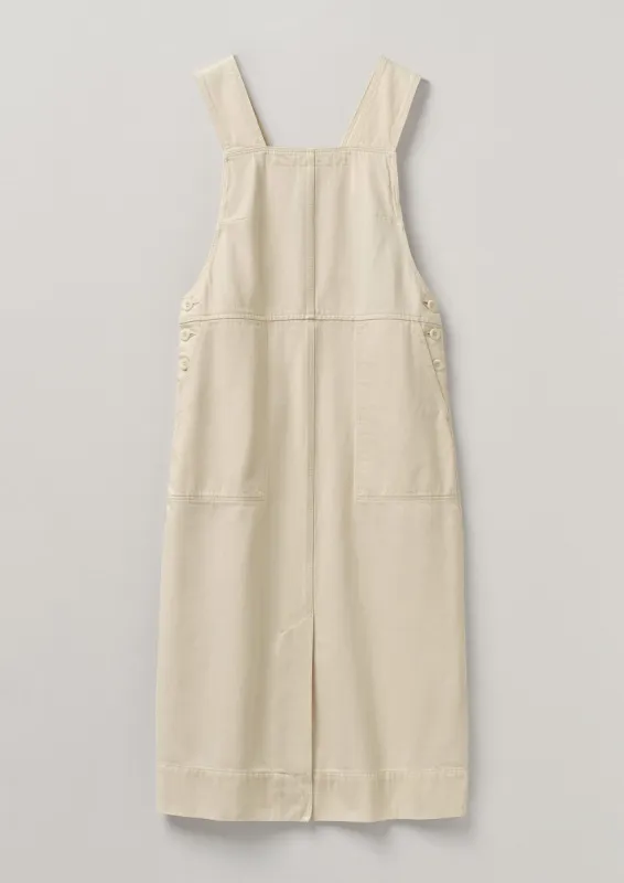 Side Button Organic Denim Pinafore Dress | Pastel Parchment sold by TOAST