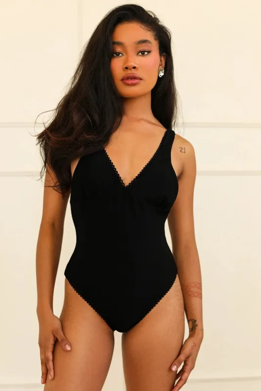 Hefner V-Neck Ruffle One Piece sold by Dippin Daisy’s