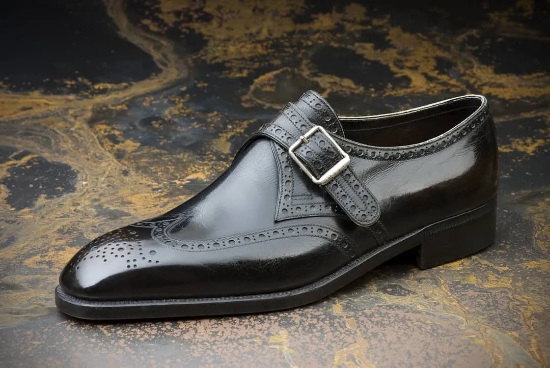 Black Leather Caranavi Brogue Wingtip Monk Strap Shoes - AW24: The Royale Collection sold by Costoso Italiano