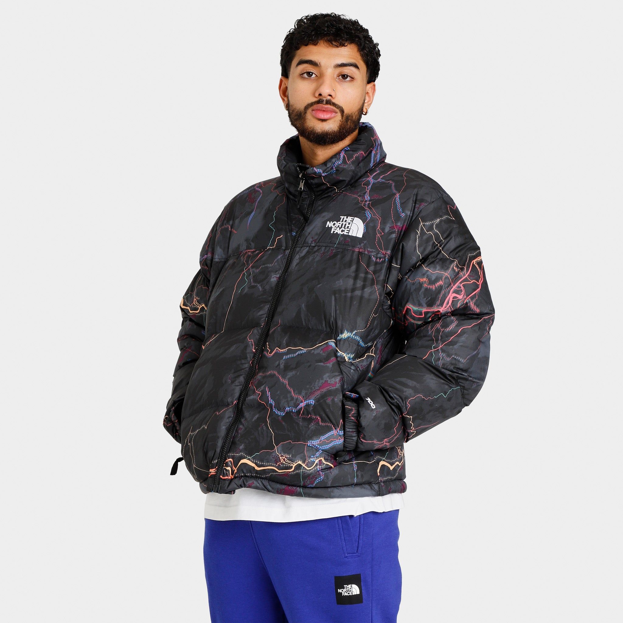 The North Face 1996 Retro Nuptse Jacket / TNF Black Trail Glow Print sold by JD Sports