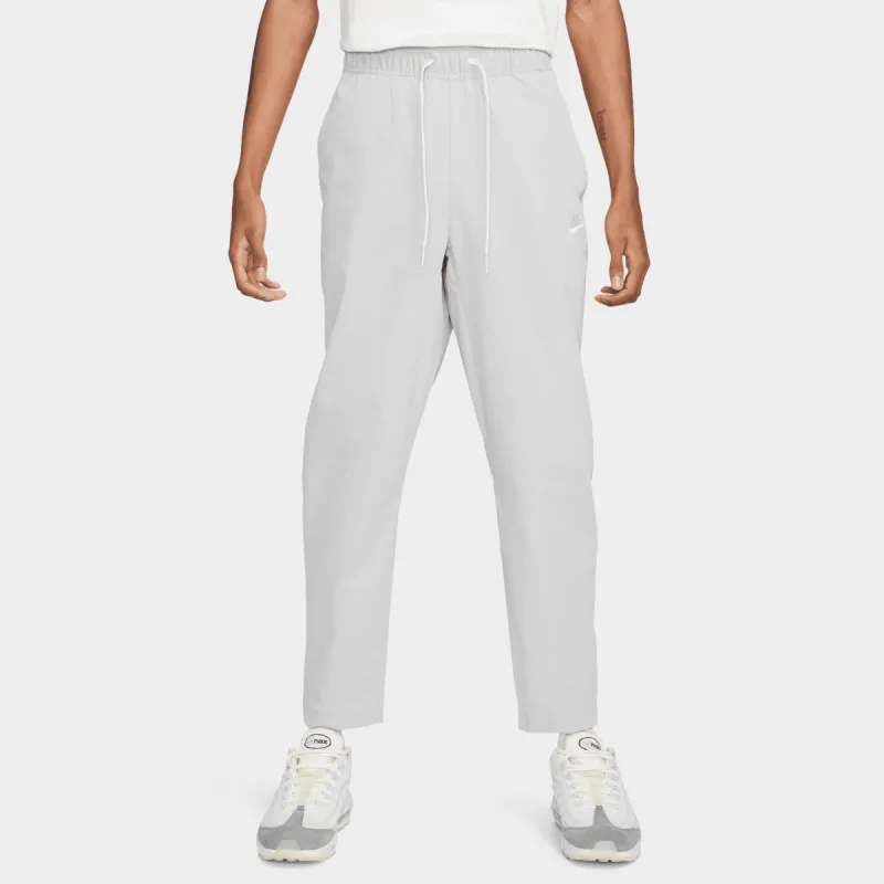 Nike Sportswear Club Woven Tapered Pants Light Smoke Grey / White sold by JD Sports