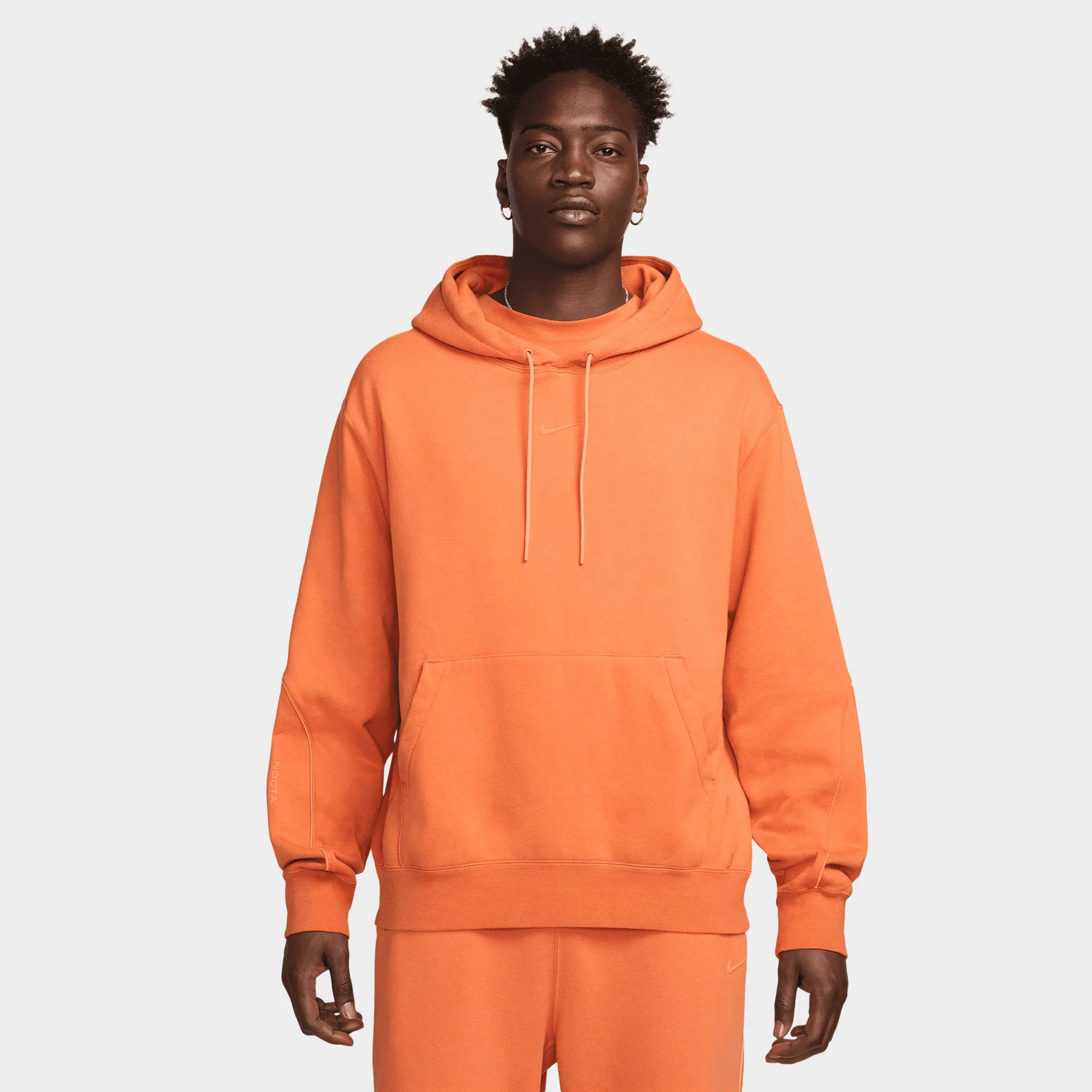 Nike NOCTA NRG Fleece Pullover Hoodie Hot Curry / Orange Trace sold by JD Sports