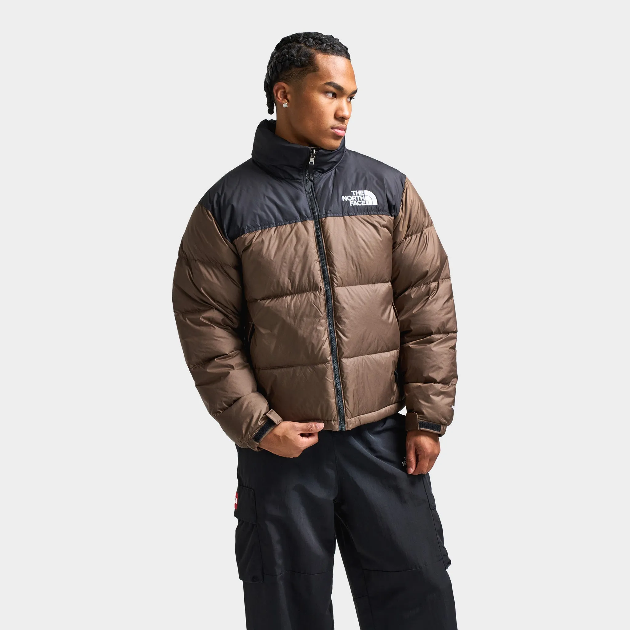 The North Face 1996 Retro Nuptse Jacket Smokey Brown / TNF Black sold by JD Sports