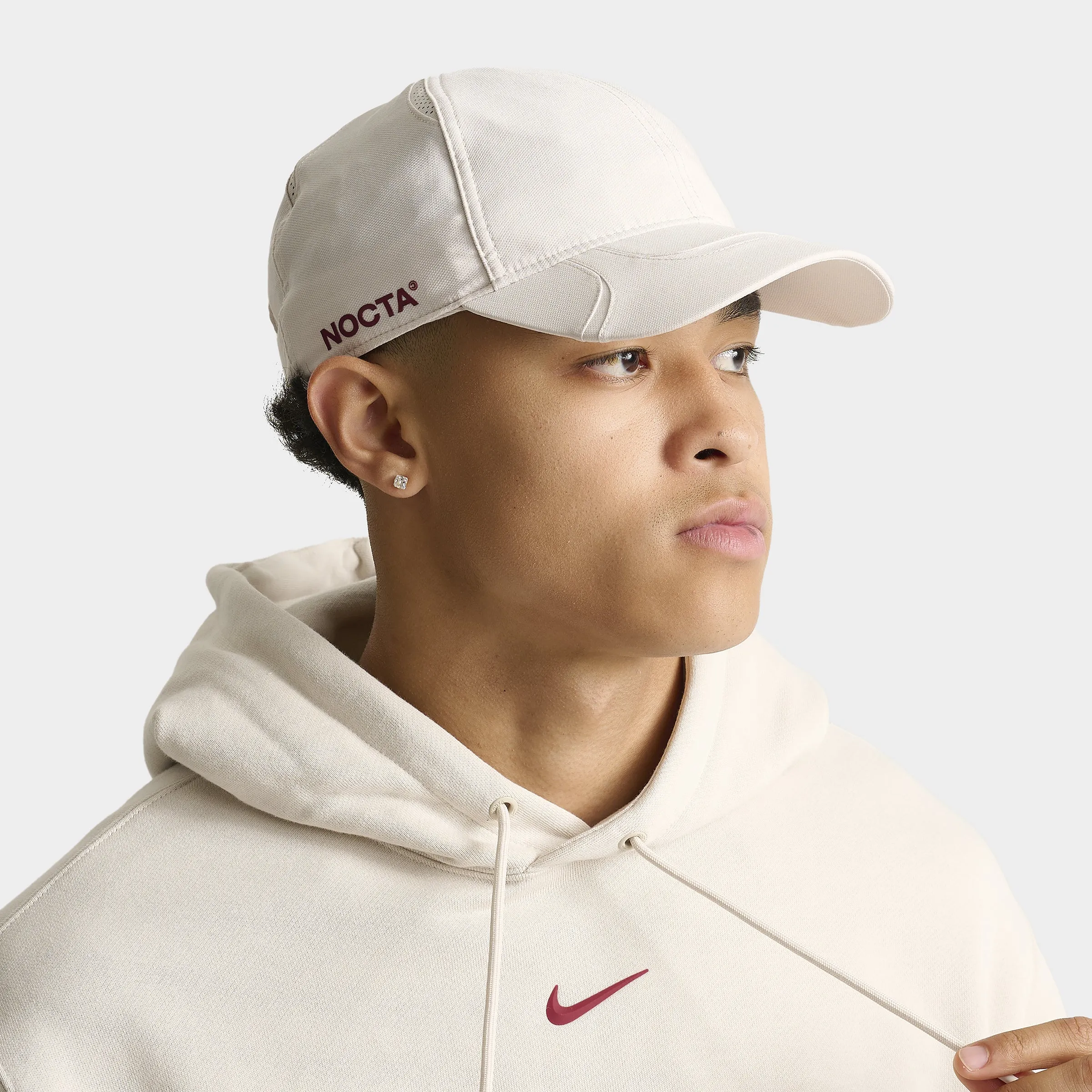 Nike NOCTA S.S.C. Cap Light Orewood Brown / Team Red sold by JD Sports