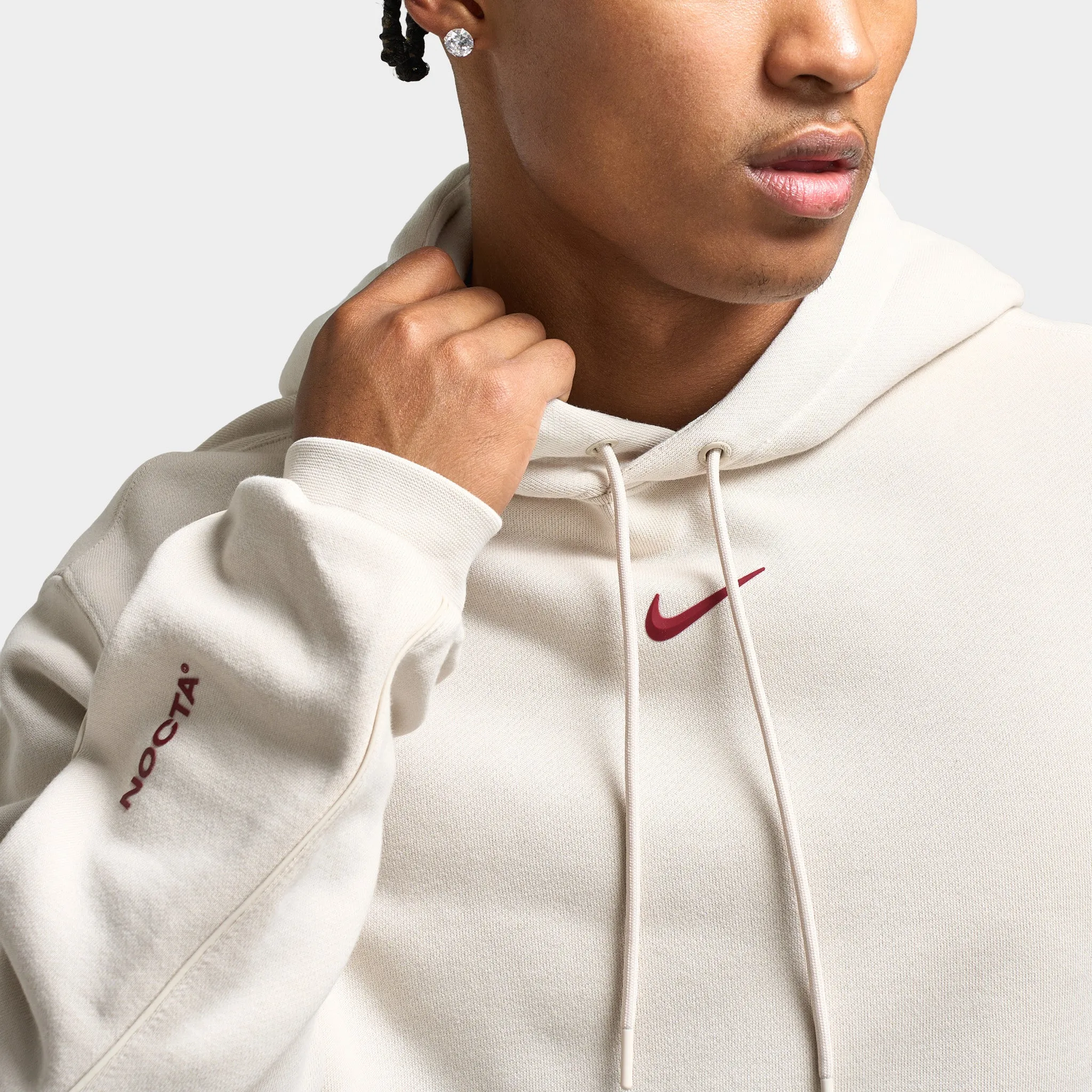 Nike NOCTA Fleece CS Pullover Hoodie Light Orewood Brown / Team Red sold by JD Sports product image thumbnail 3