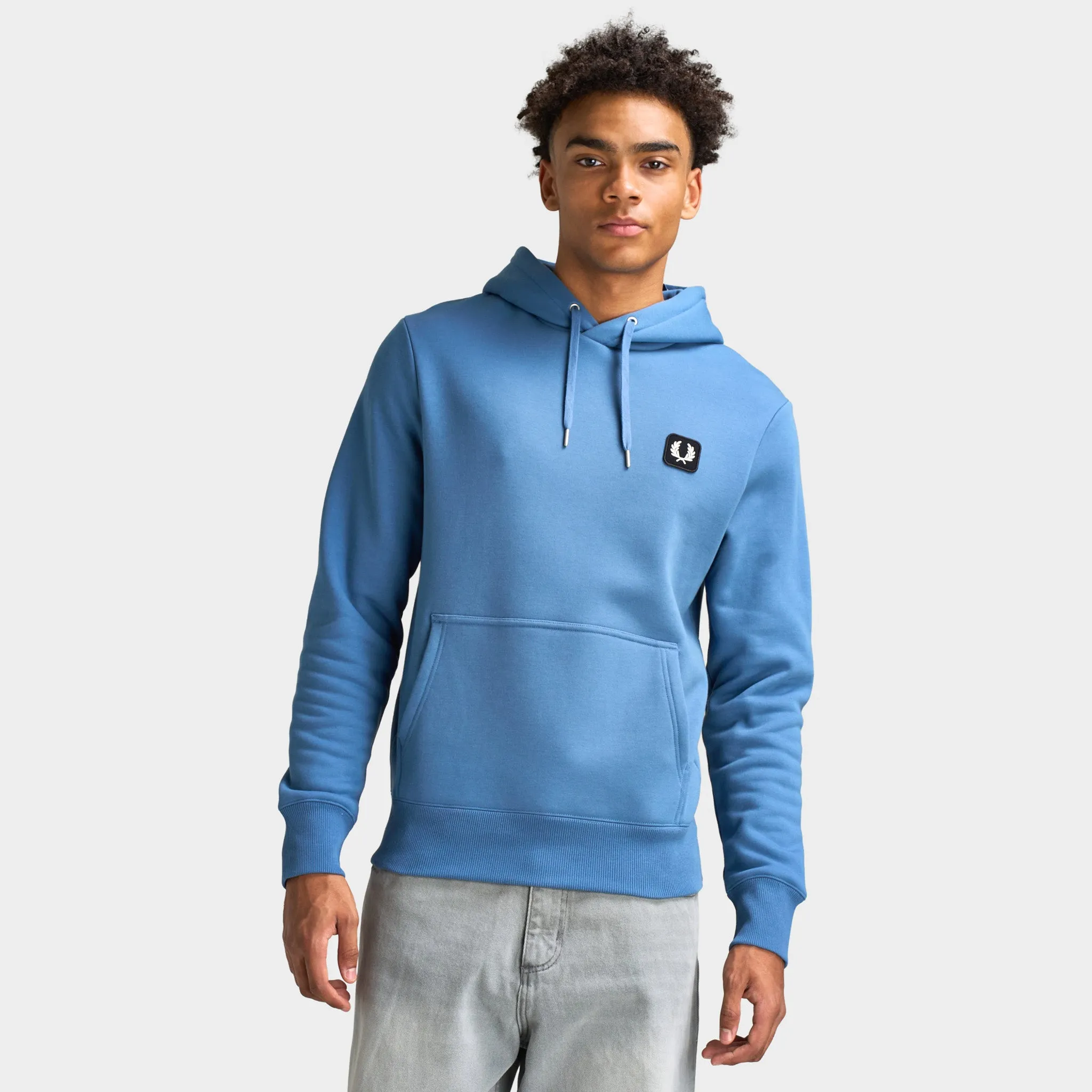 Fred Perry Badge Hoodie / Ace Blue sold by JD Sports