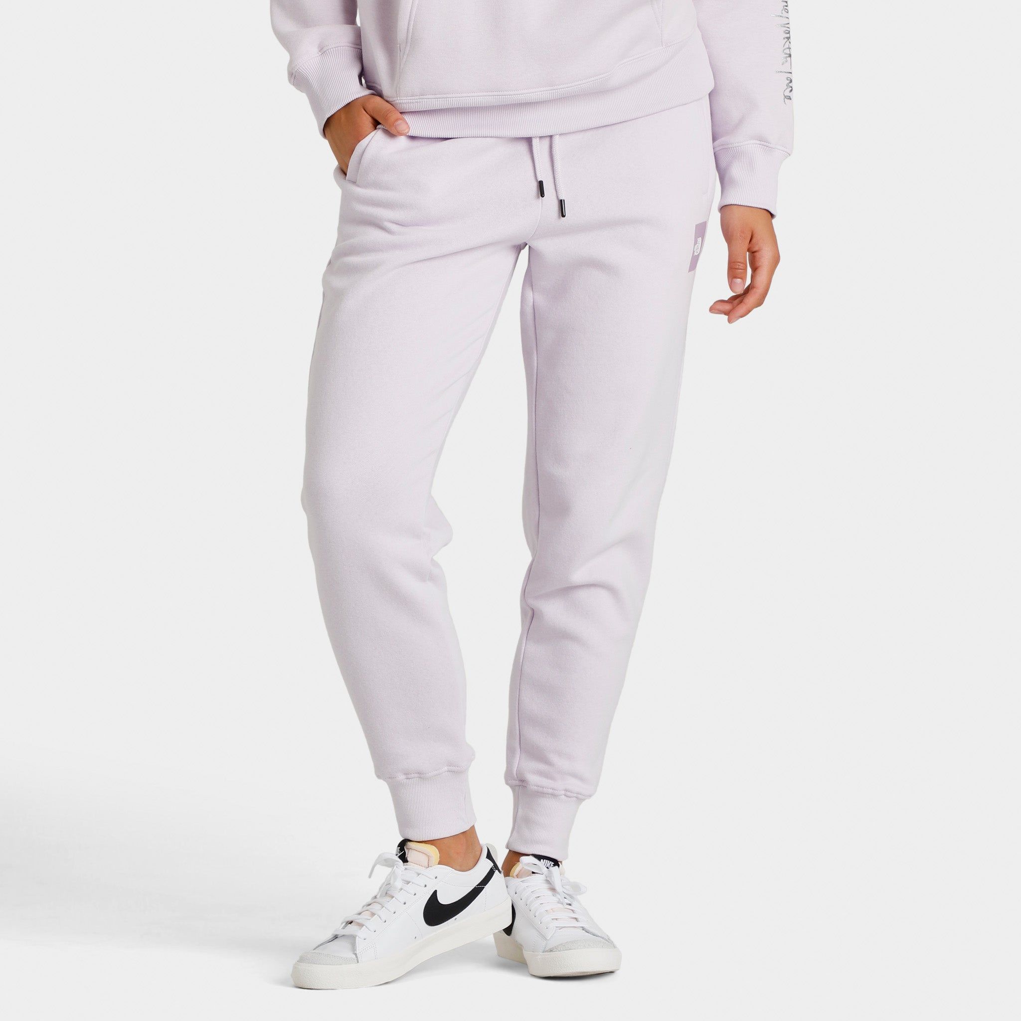 The North Face Women's Box NSE Joggers Lavender Fog / Lavender Fog sold by JD Sports