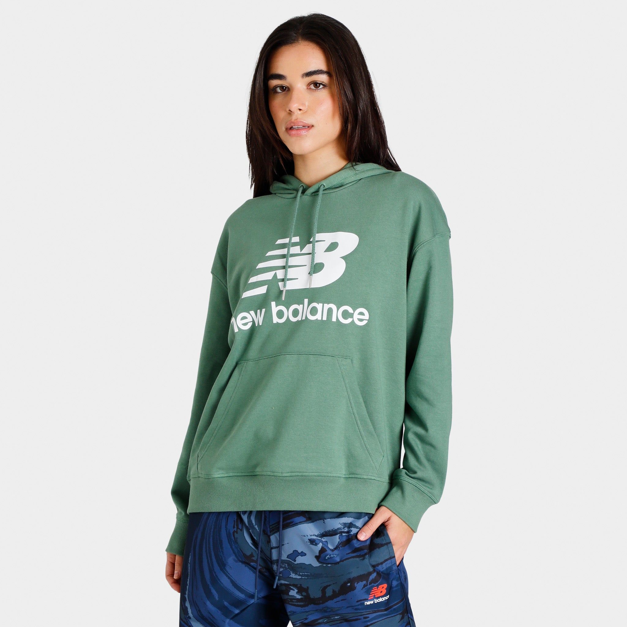 New Balance Women’s Essentials Stacked Logo Oversized Pullover Hoodie / Jade sold by JD Sports