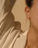 Large Thin Infinity Hoops sold by Midori Jewelry Co.