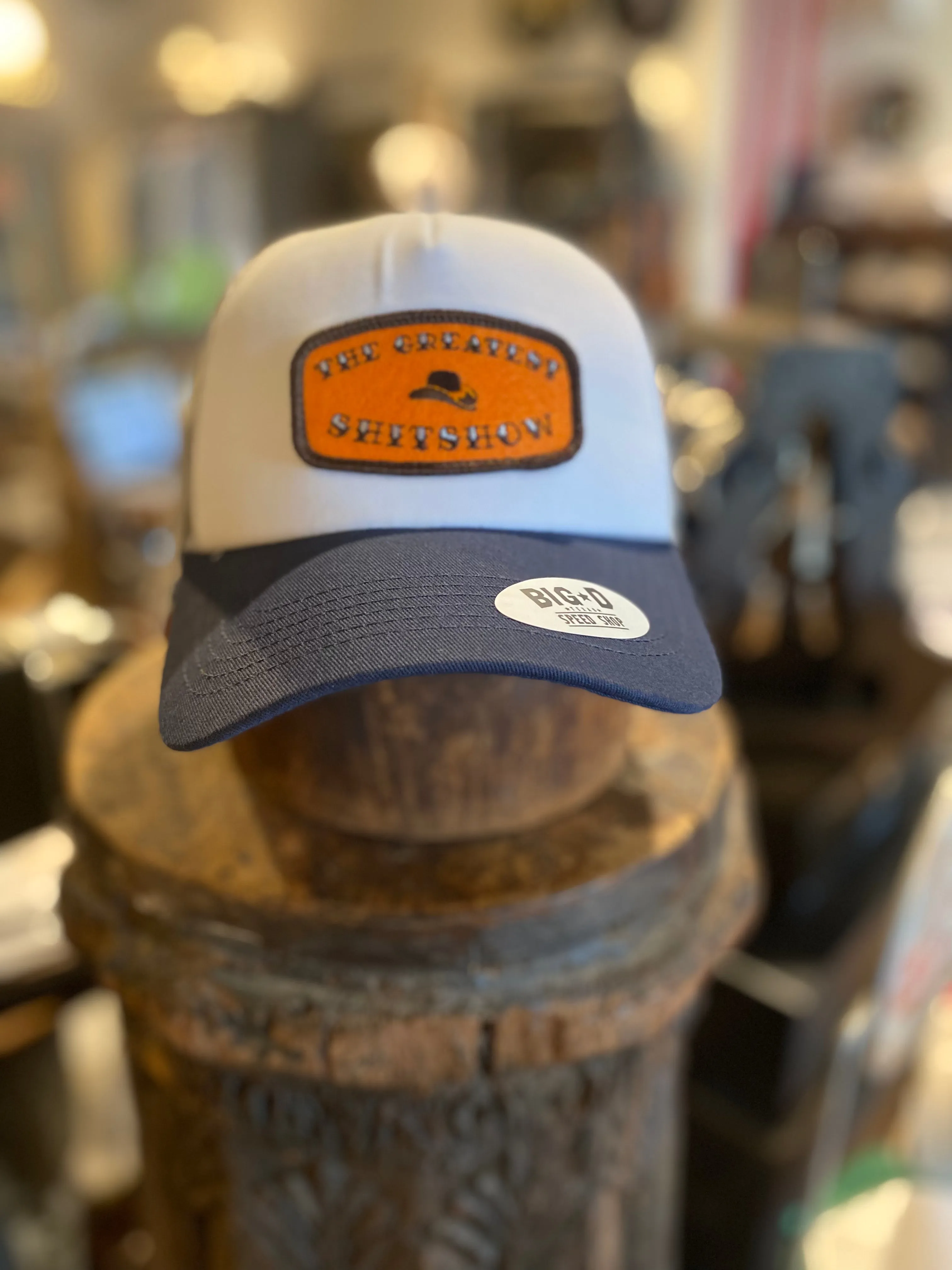 The Greatest $h!t$how - Orange Patch on White/Grey/Navy Trucker sold by Cave and Post