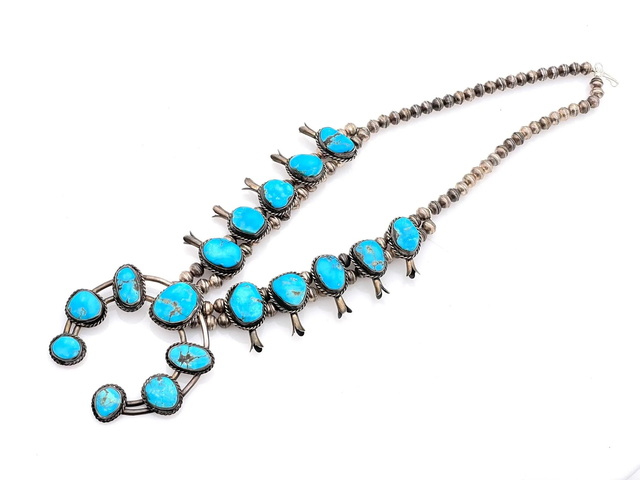 NATIVE AMERICAN STERLING TURQUOISE SQUASH BLOSSOM NECKLACE sold by Cave and Post