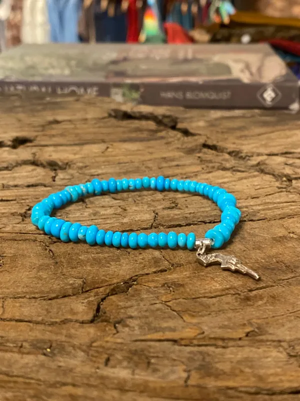Sleeping Beauty Turquoise Mixed Rondelle Bead Stretch Bracelet with Sterling Silver Pistol Charm sold by Cave and Post
