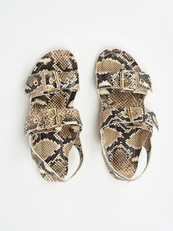 The Double Buckle Sandal in Python sold by Jamie Haller