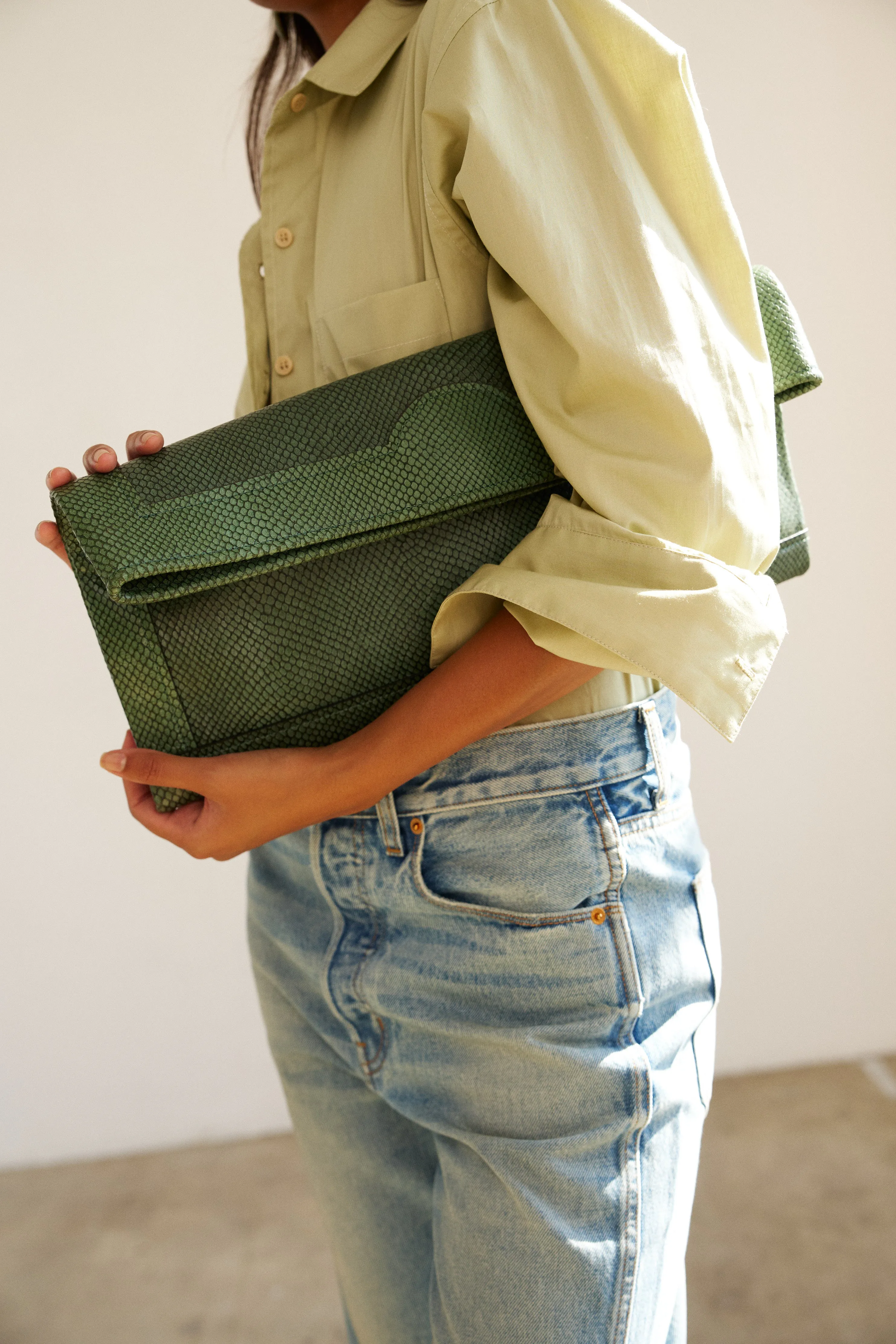 The Document Clutch in Green Snake sold by Jamie Haller