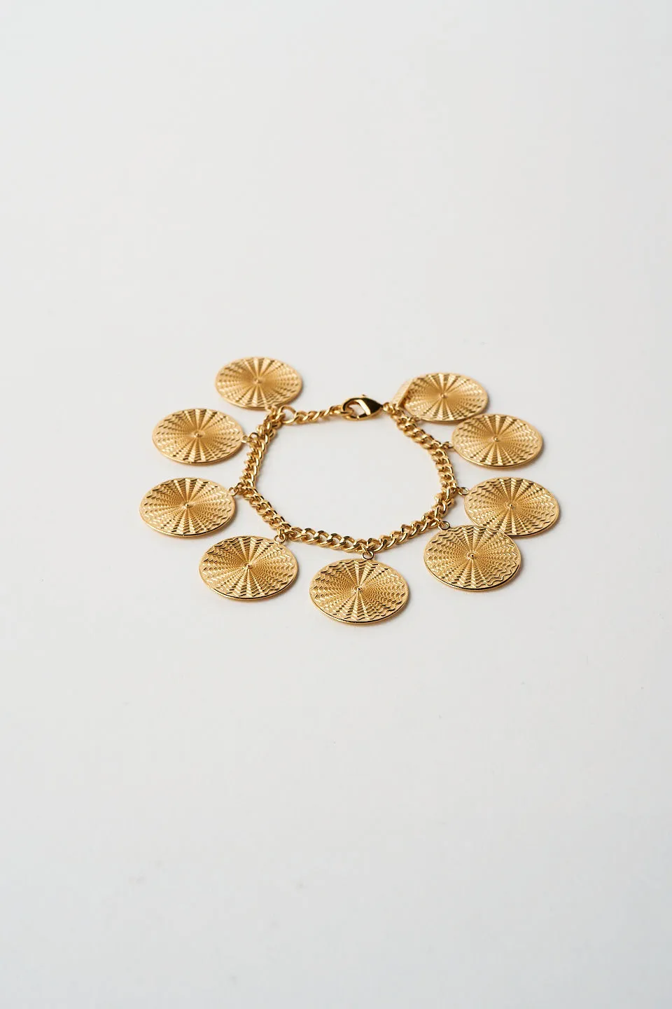 The Chaos Sunburst Charm Bracelet in Gold sold by Jamie Haller