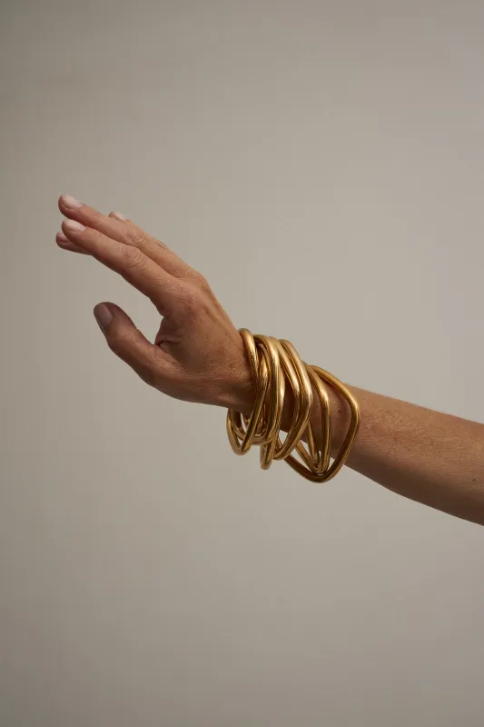 The Interlocking Bangle in Gold made by Jamie Haller