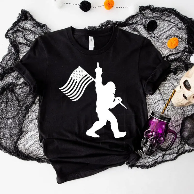Bigfoot Holding A Flag Short Sleeve T-shirt sold by GTHIC