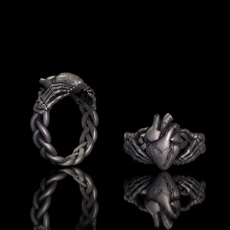 Gothic Skull Hands Holding Heart Sterling Silver Ring sold by GTHIC