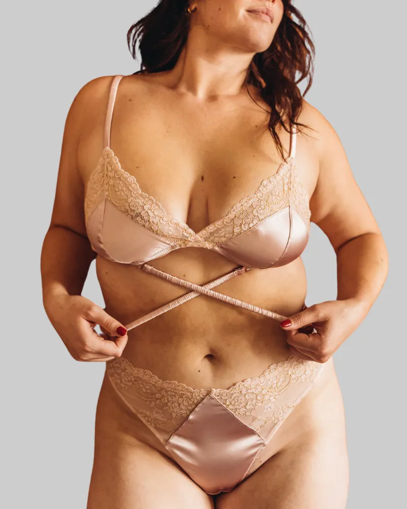 UC x Beth Jones Satin & Lurex Lace Bralette and Thong Set in Blush sold by Underclub