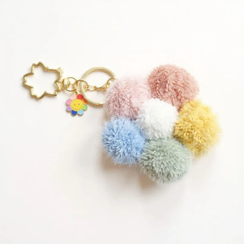 Anna-Kaci Multicolor Pom Pom Keychain with Gold Flower Charm and Smiley Accent sold by Anna-Kaci
