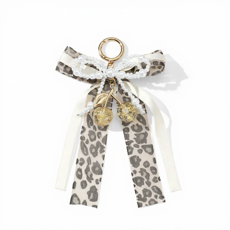 Anna-Kaci Leopard Print Ribbon Keychain with Pearl Bow and Cherry Charms sold by Anna-Kaci