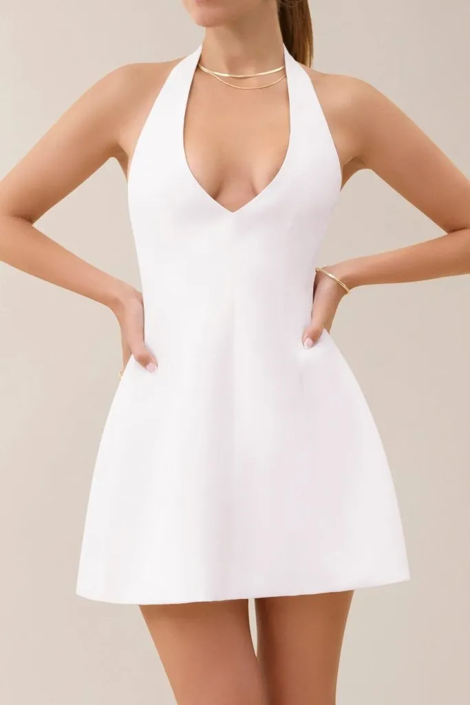 White a-line plunging neckline flare mini dress sold by Heiress Beverly Hills