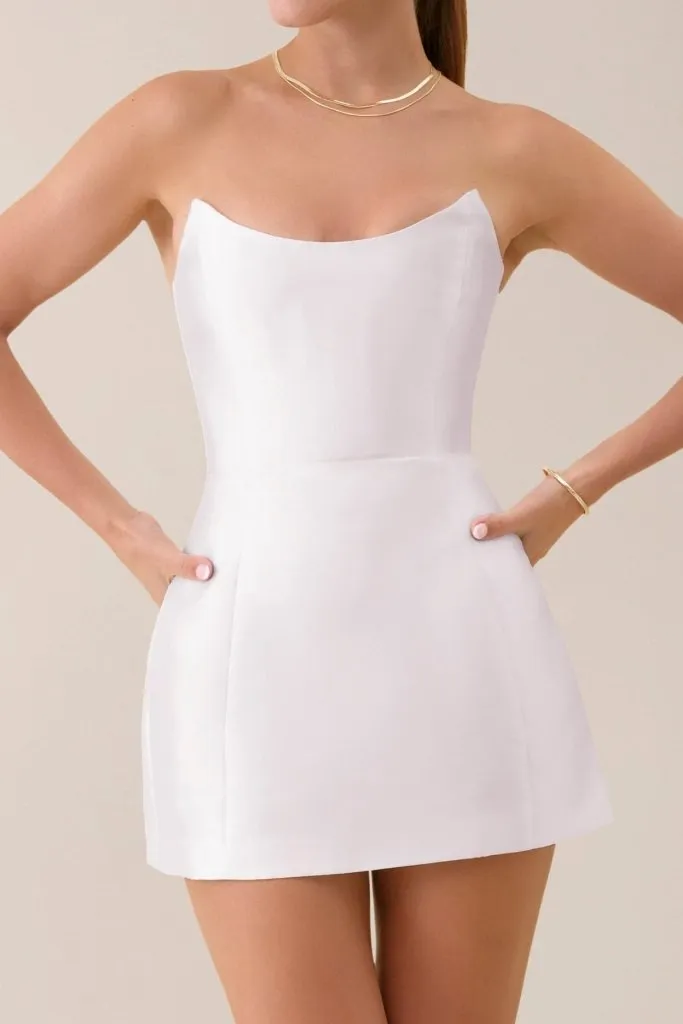 White strapless sheen corset mini dress sold by Heiress Beverly Hills