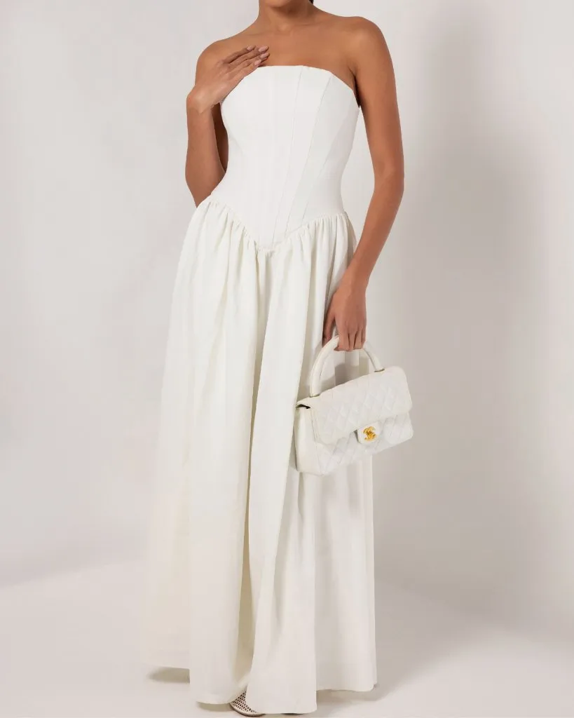 White strapless corset crepe flare maxi dress sold by Heiress Beverly Hills