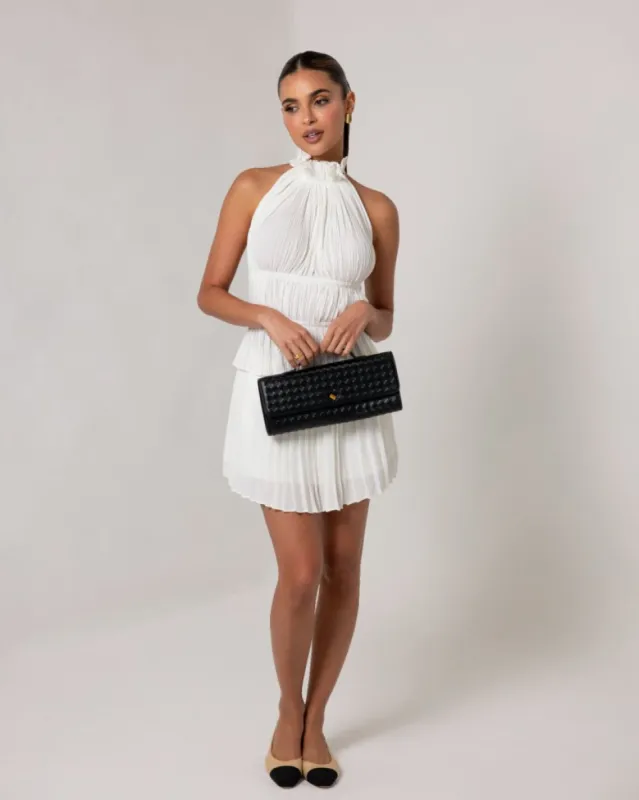 Cream pleated mini skirt sold by Heiress Beverly Hills