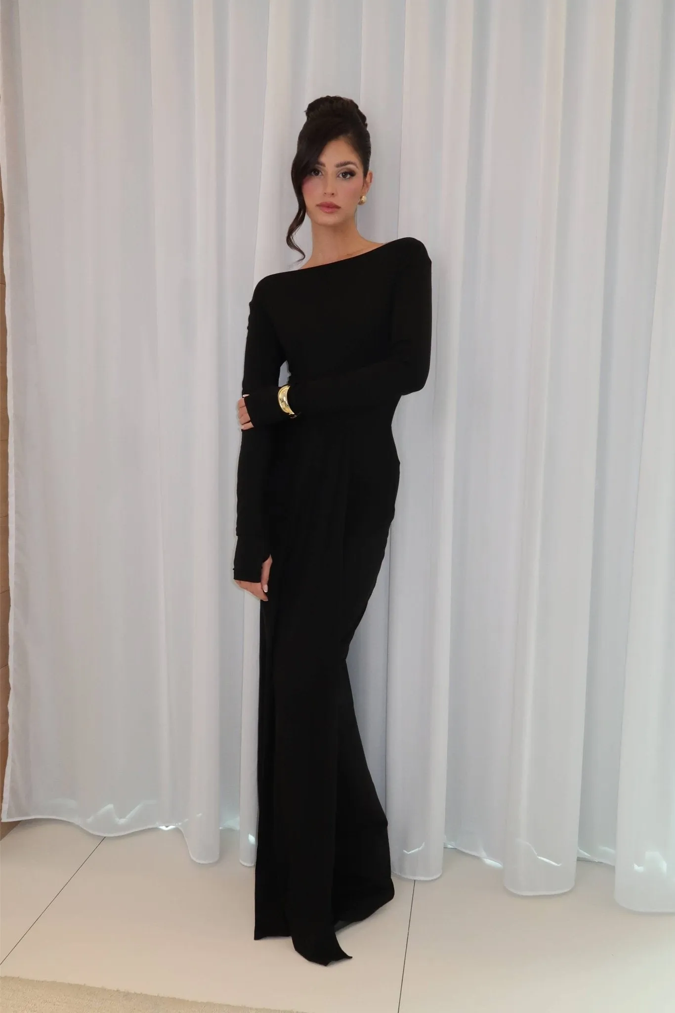 Black long sleeve twisted knit maxi dress sold by Heiress Beverly Hills