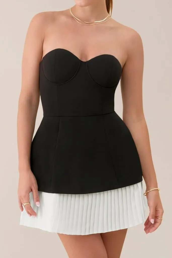Black strapless a-line pleated mini dress sold by Heiress Beverly Hills