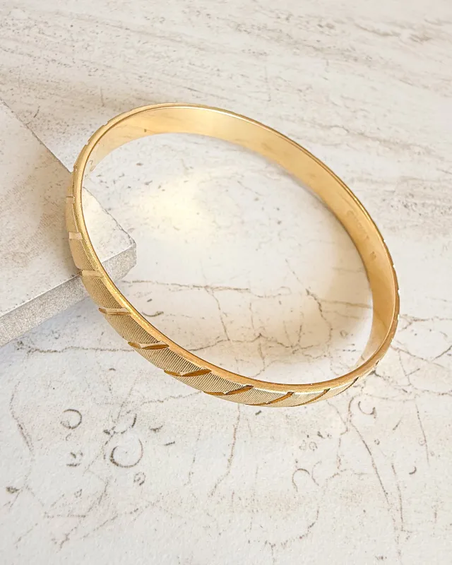 Vintage MONET Signed Gold Metal Bangle Bracelet sold by Care Tucker