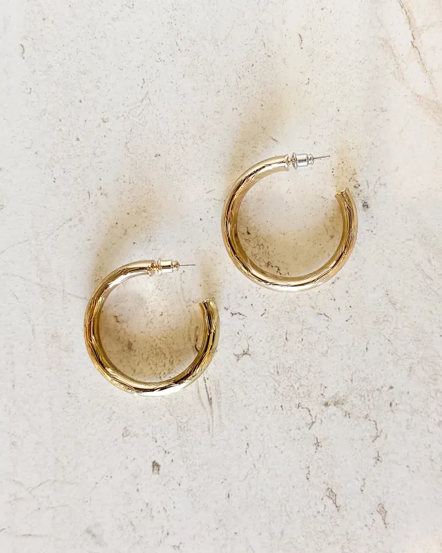 Lightly Textured Gold Hoop Earrings sold by Care Tucker