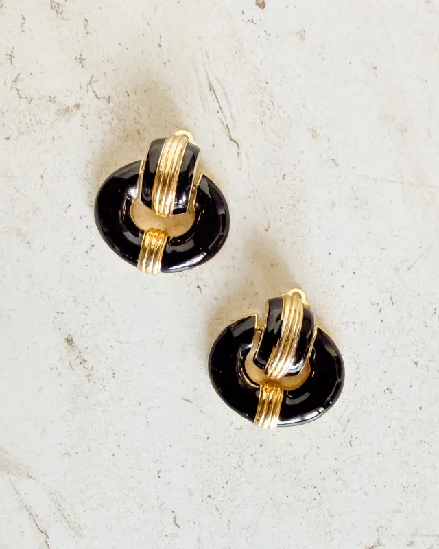 Vintage black and gold tone clip on earrings sold by Care Tucker