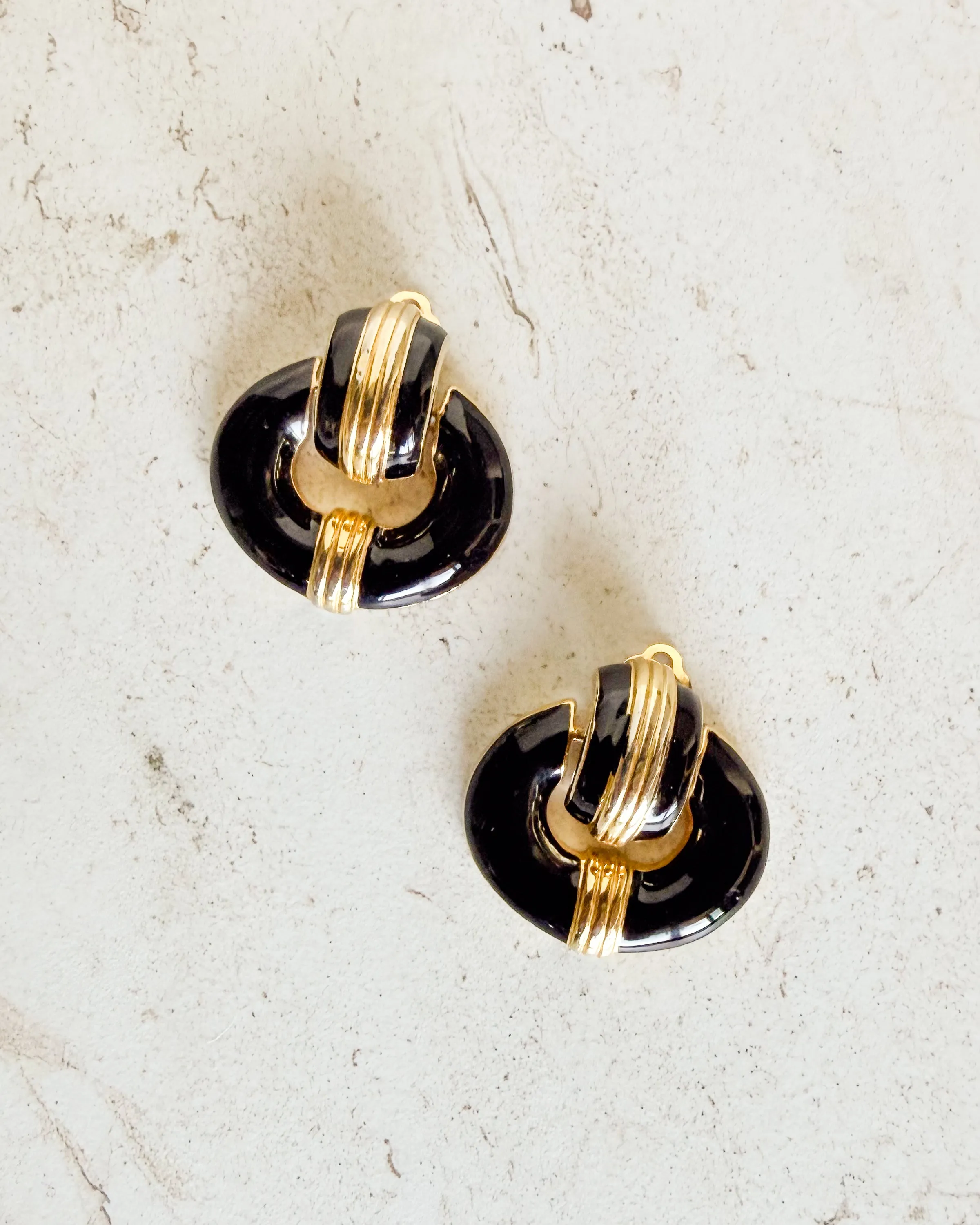 Vintage black and gold tone clip on earrings sold by Care Tucker