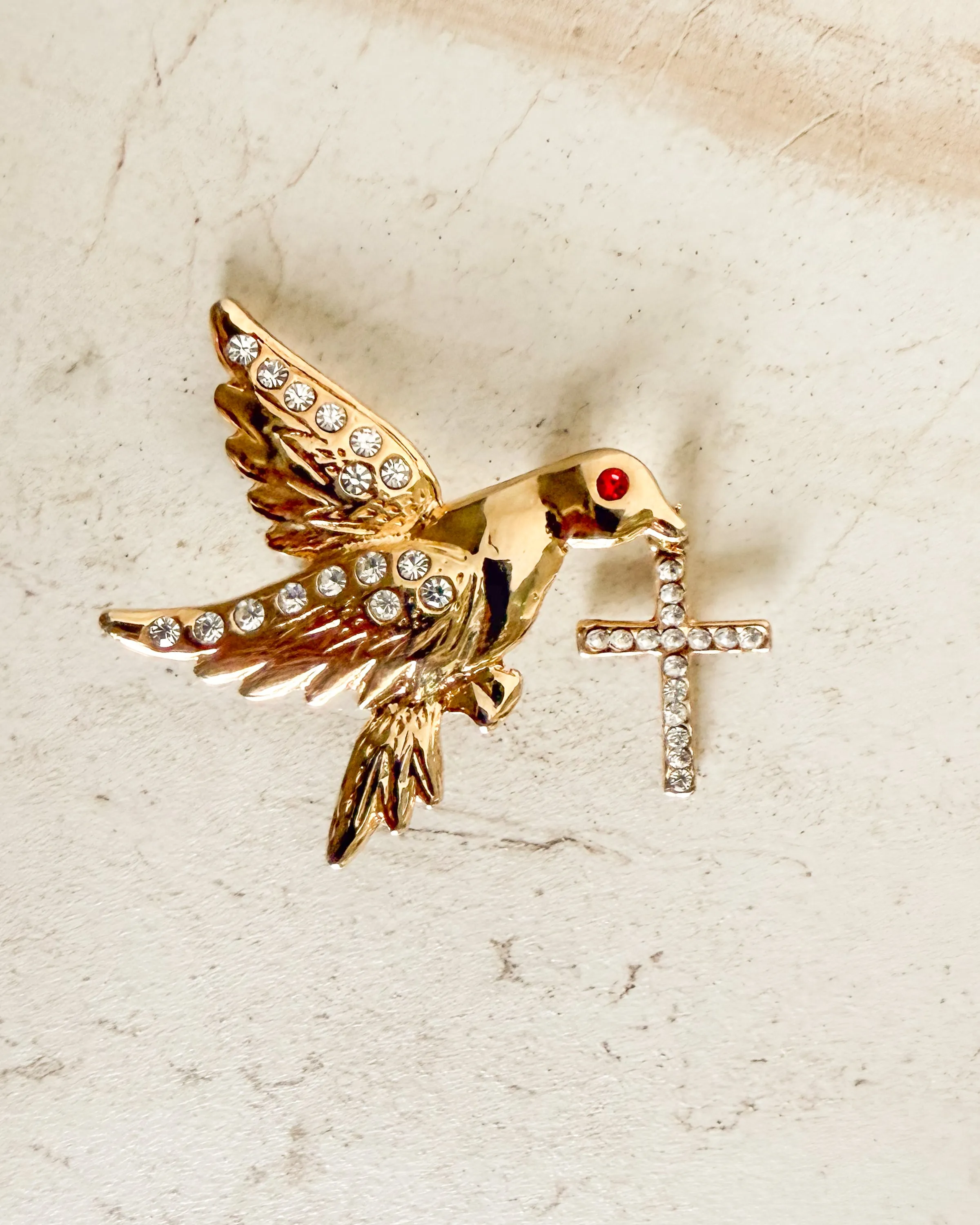 Vintage Gold Dove Red Eye Bird with Cross Brooch sold by Care Tucker