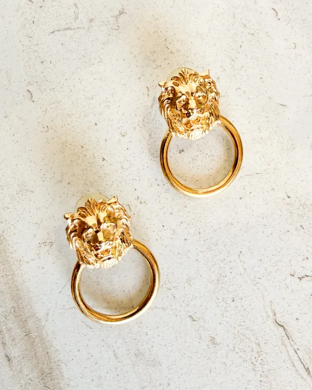 Vintage lion head hanging hoop earrings sold by Care Tucker