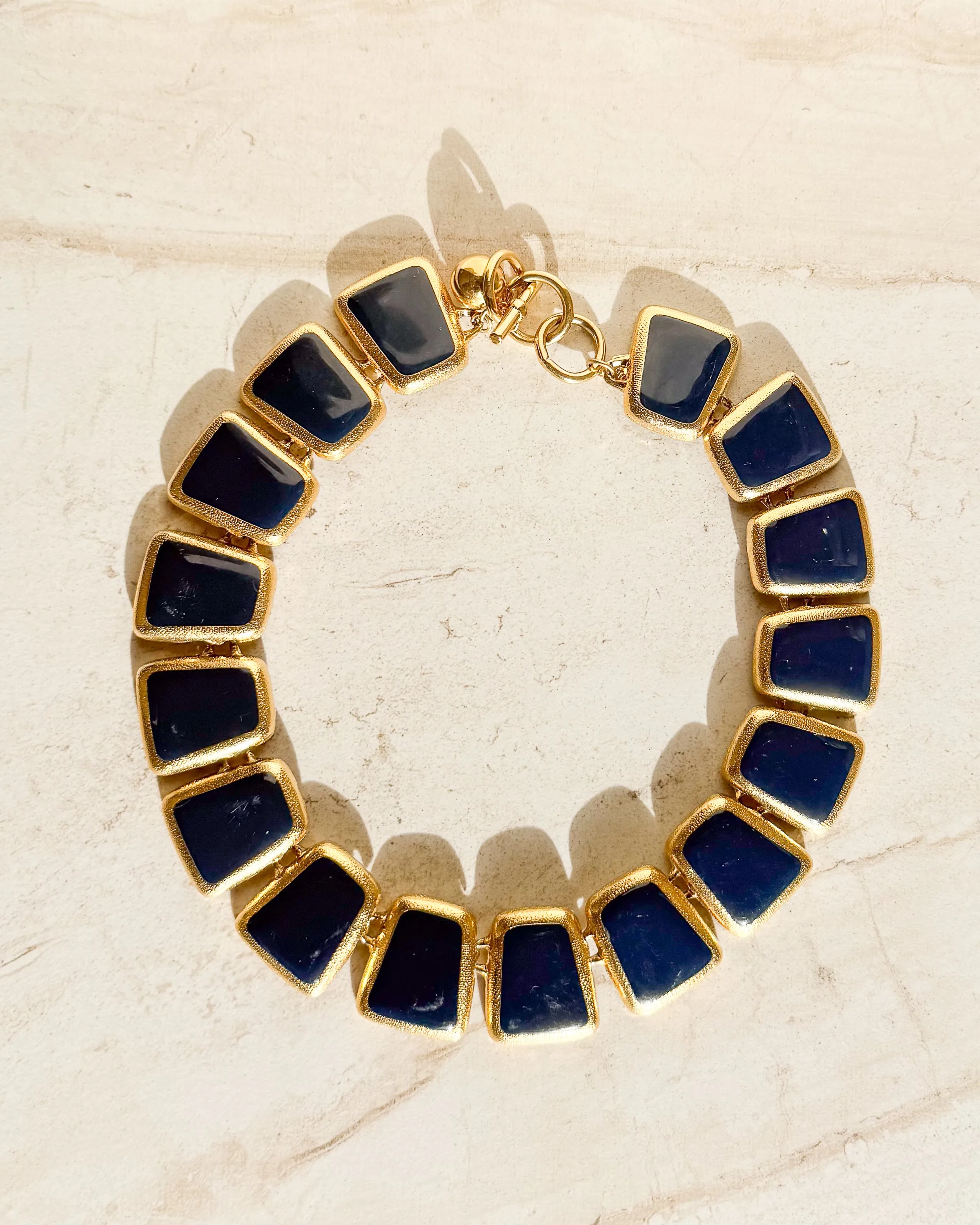 Vintage Designer gold tone and blue enamel wedge Necklace sold by Care Tucker