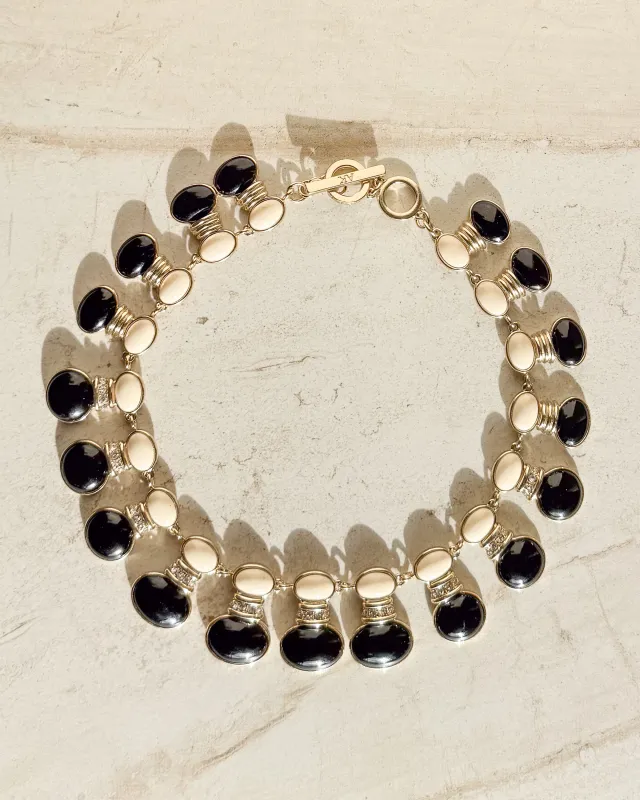 Vintage SIgned black and off-white enamel oval necklace sold by Care Tucker