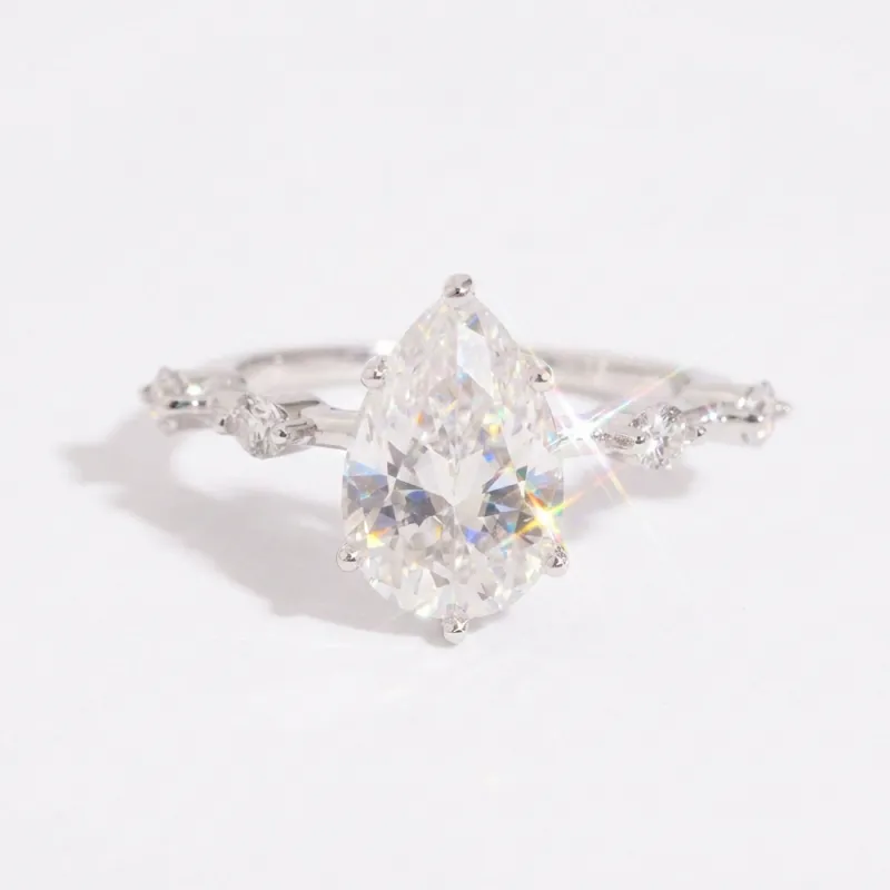 Eterna Pear Cut Moissanite Ring with Accent Stones made by Ghetluxe