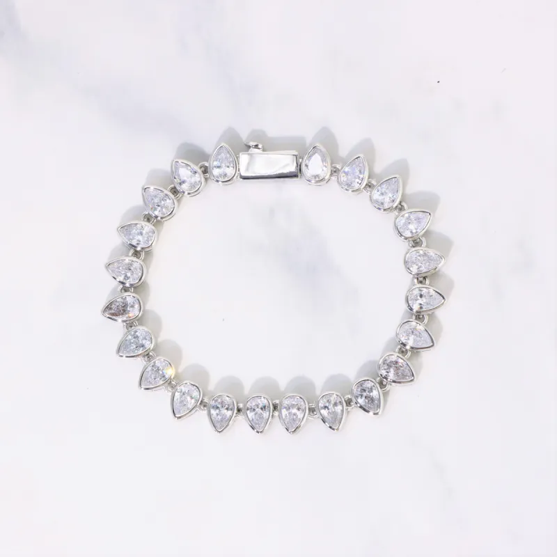 Women's Pear Cut Bezel Tennis Bracelet in White Gold sold by Ghetluxe